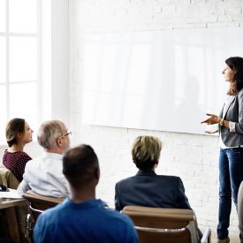 professional presenting in meeting woman s