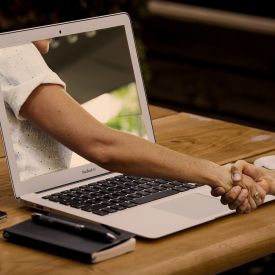 Handshake through Laptop Screen