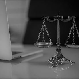 A gray image of a balance in front of a computer implying that all modalities should be equivalent.