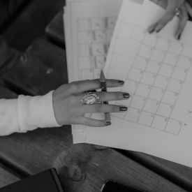 A gray image of a person planning her course calendar