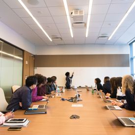 a group discussing a topic in a large meeting room