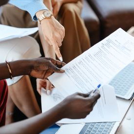 multiple hands holding the same document