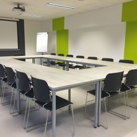 a room setup with desks in a rectangle formation