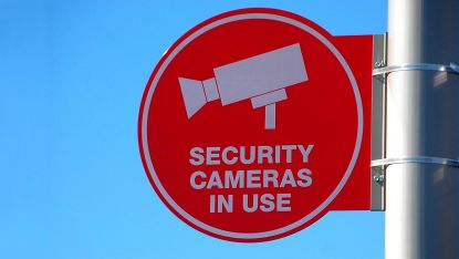 a cctv sign mounted to a wall