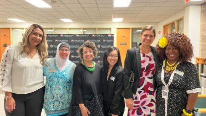 Six members of NFLA standing together in a classroom smiling.